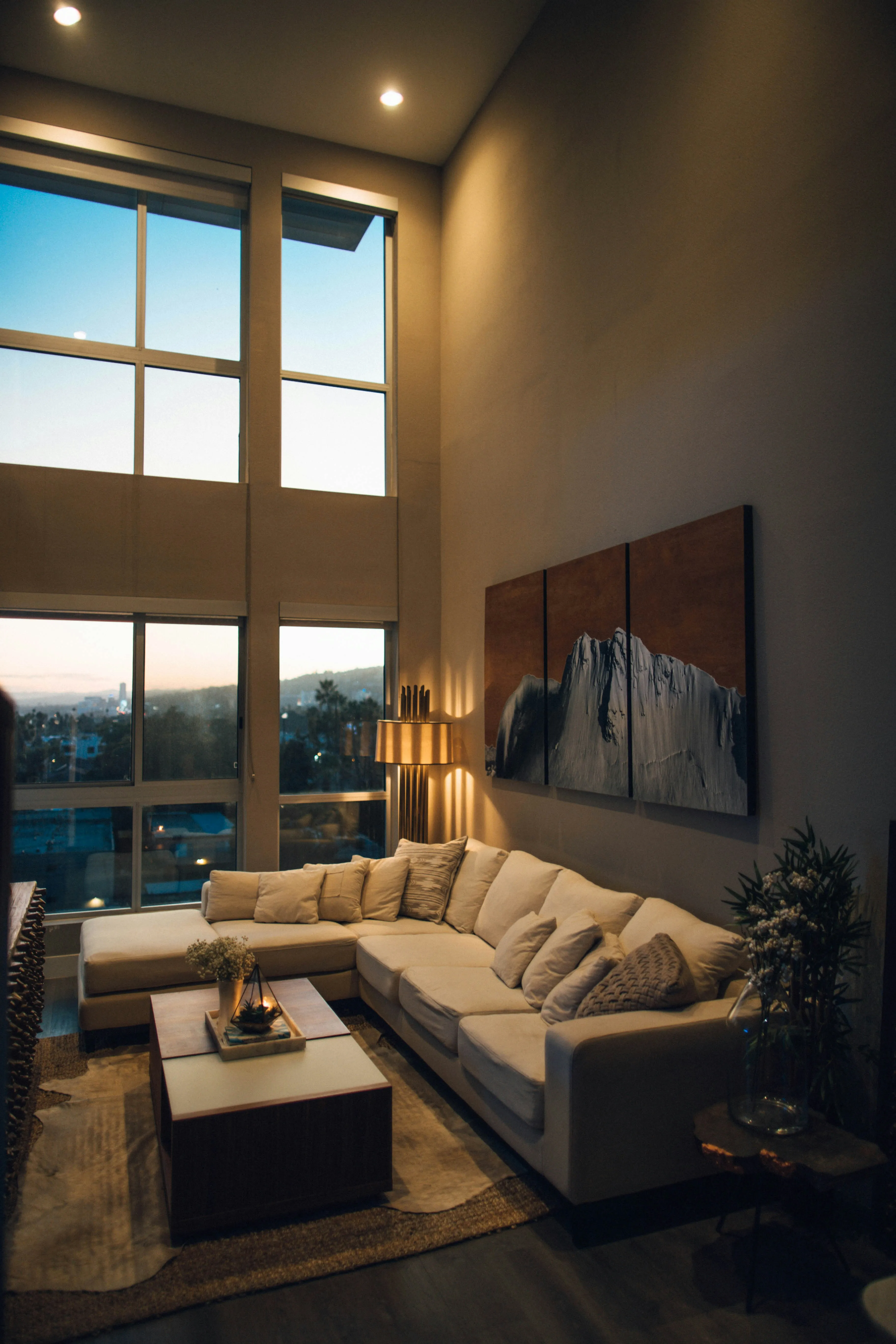 A warm, well-appointed living room at dusk